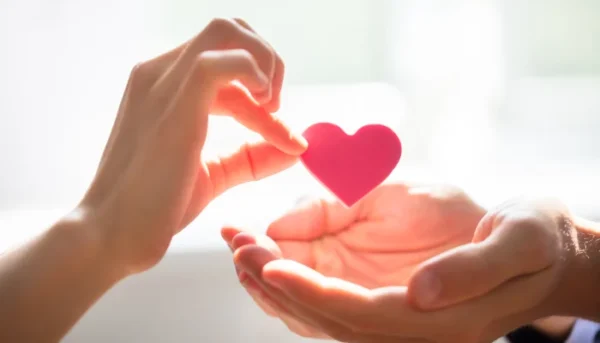 person giving a heart to someone