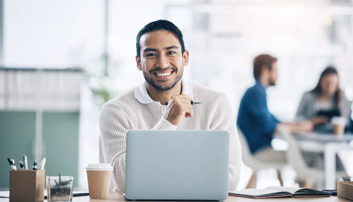 smiling man behind a computer