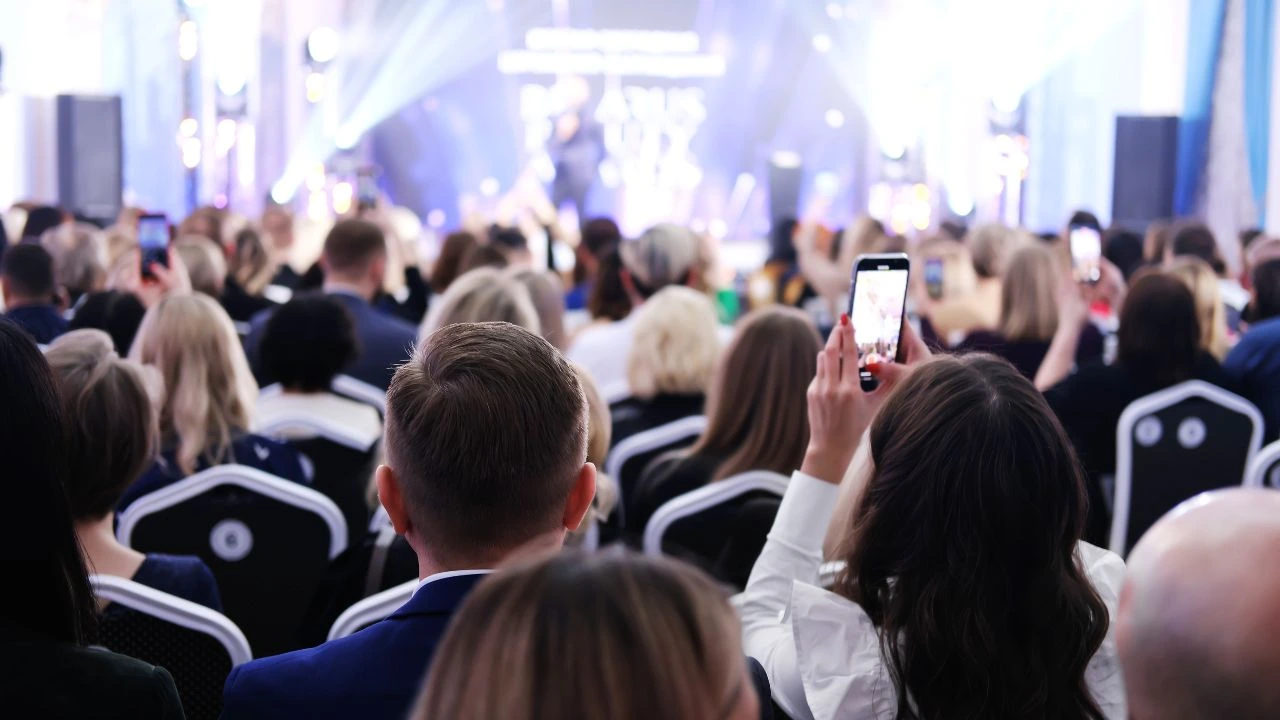 Girl filming an event on the phone Girl filming an event on the phone