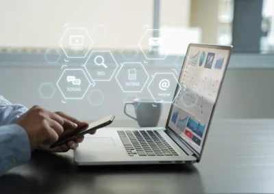 Person interacting with smartphone and laptop displaying digital marketing analytics with overlaid icons for SEO, social, mobile, video, and email.